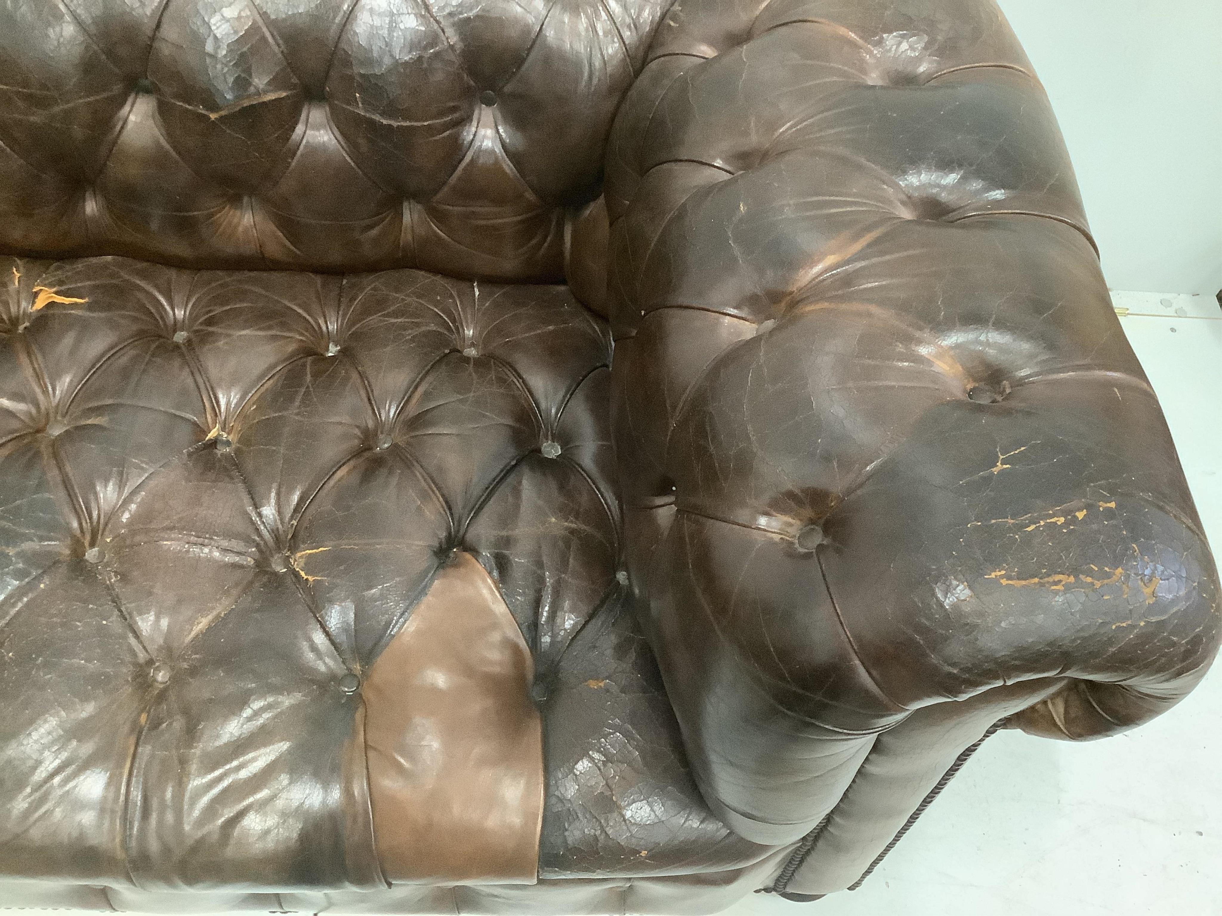 An early 20th century buttoned brown leather Chesterfield sofa, width 200cm, depth 90cm, height 72cm. Condition - fair, some patching and minor tears